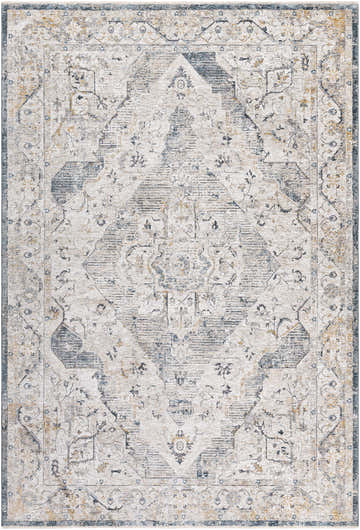 Close-up of the Wadeye Luxe Fringe Rug, a machine-woven rug with a traditional pattern in dark blue, gray, and mustard tones. Design-Rectangle-6796