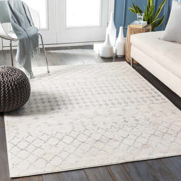 Living room scene with a light gray Warton Area Rug, off-white sofa, gray pouf, and white accents. Bohemian farmhouse style. Roomscene-Rectangle