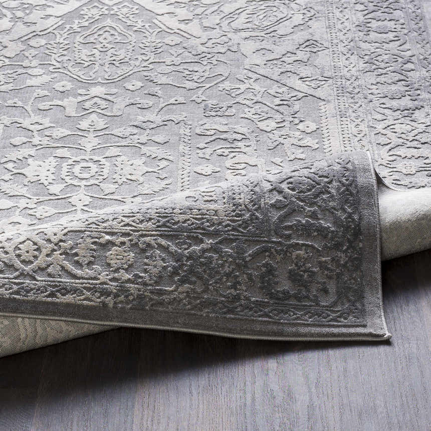 Close-up of the Watford Updated Traditional Tibetan Rug in charcoal and gray, showing the intricate vintage-style pattern and texture. Fold