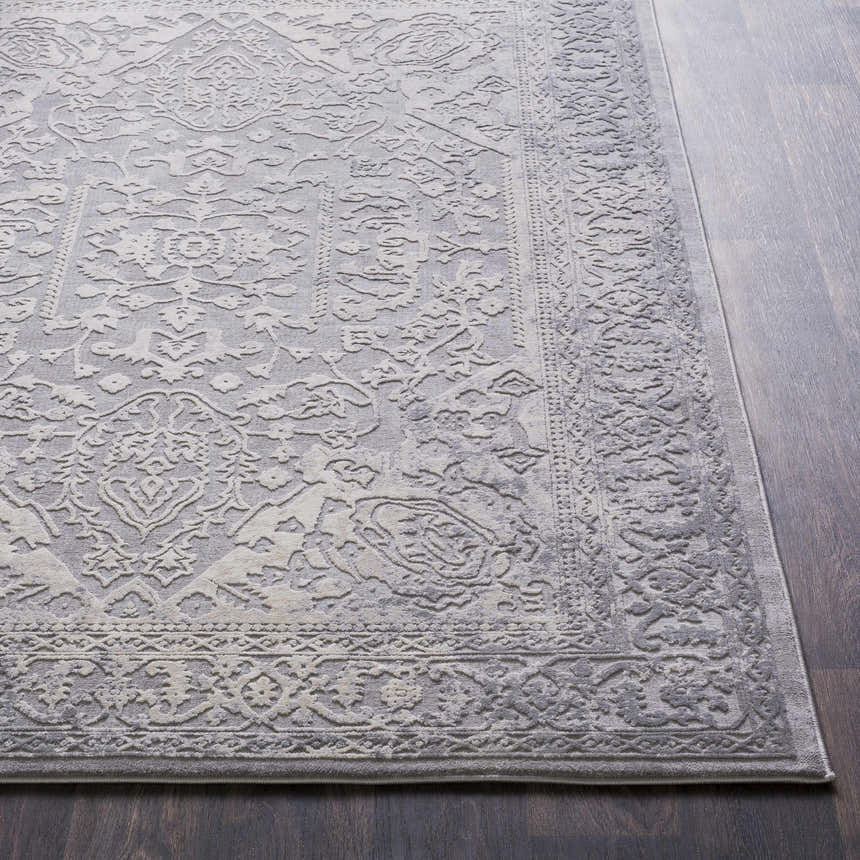 Close-up of the Watford Updated Traditional Tibetan Rug. Charcoal, gray, and ivory tones with a vintage, floral-inspired pattern. Front