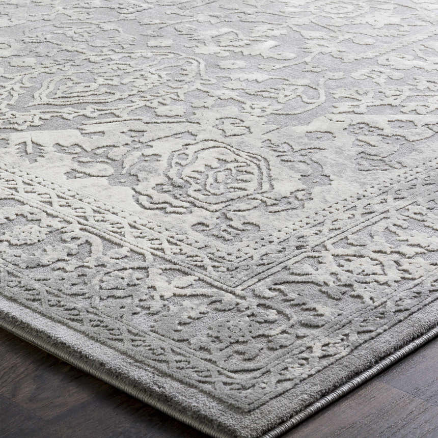 Close-up of the charcoal and ivory Watford Updated Traditional Tibetan Rug, showing its intricate vintage-style pattern. Texture
