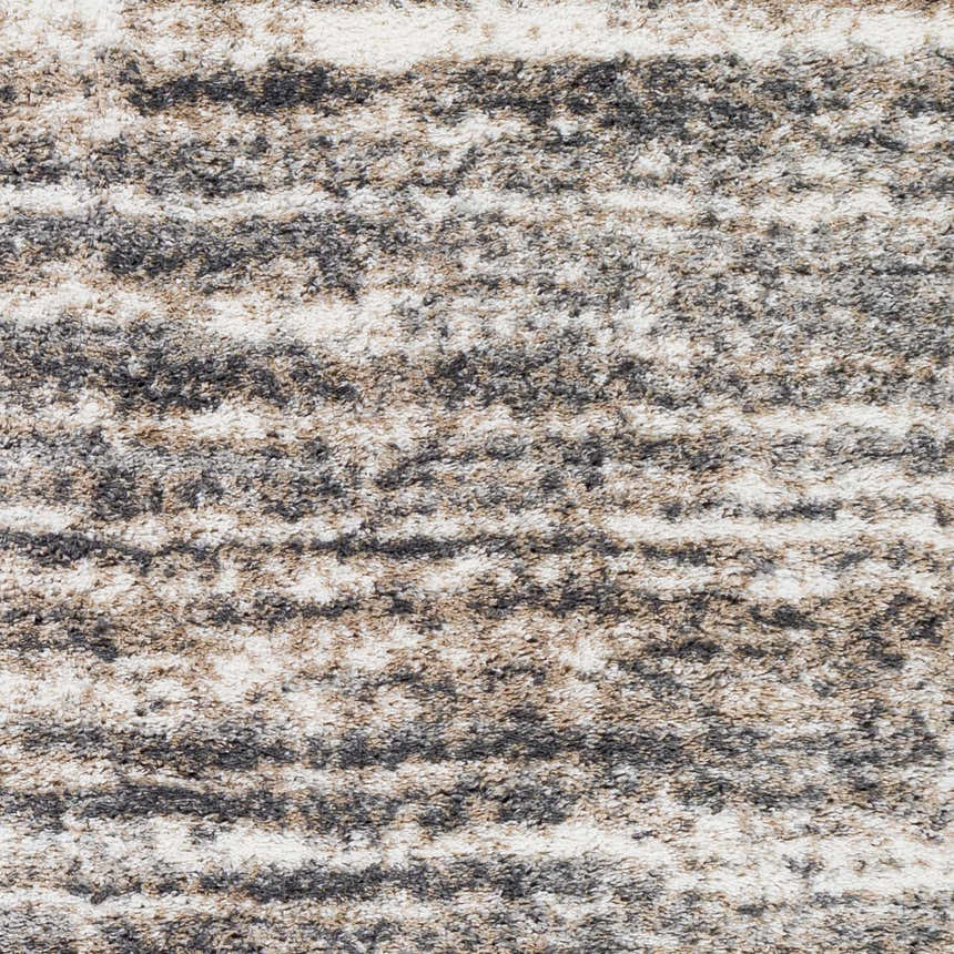 Close-up of the Weddin Striped Plush Area Rug, showcasing its charcoal, cream, gray, and tan striped shag texture. Swatch