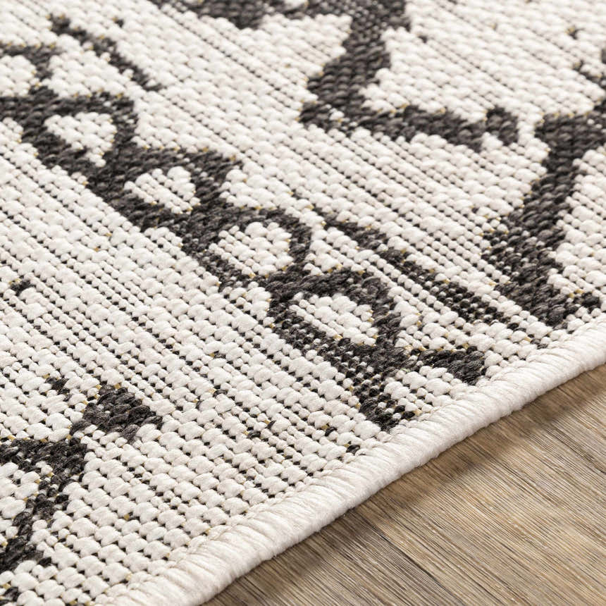 Close-up of the Westside Outdoor Area Rug. Black and white bohemian pattern, machine woven texture. Texture