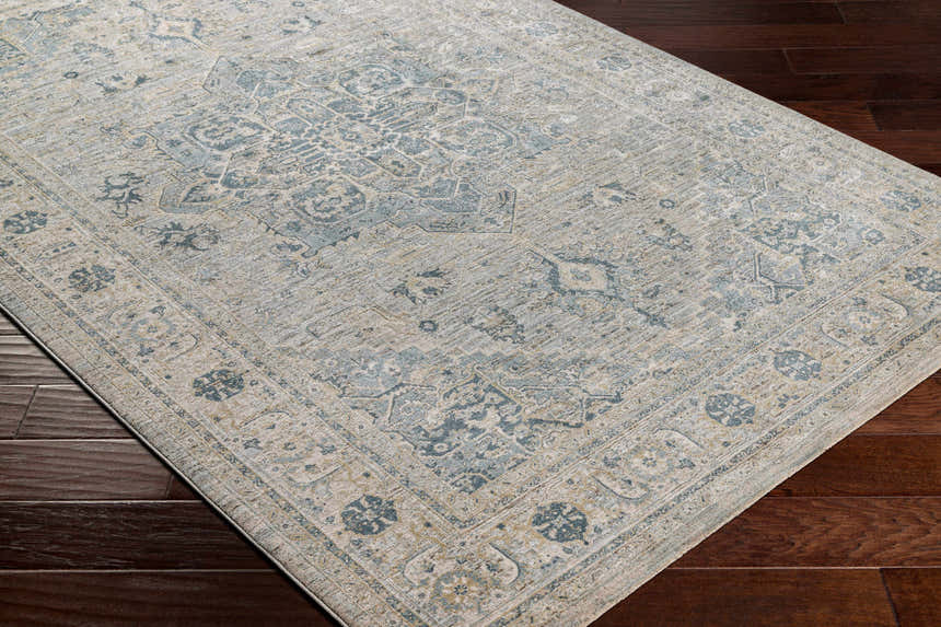 Close-up of the Whangamata Thick Luxe Boutique Rug. Features a traditional, light gray and pale blue oriental pattern. Corner