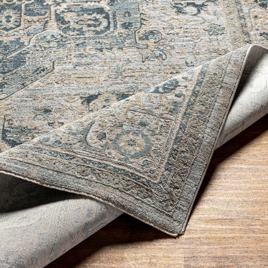Close-up of the Whangamata Thick Luxe Boutique Rug showing the traditional design in dusty sage, light gray, and taupe. Fold