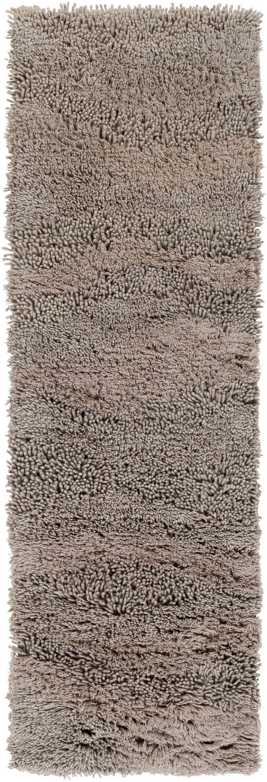 Close-up of the hand woven Wharton Carpet. The 100% NZ Wool rug has a shaggy texture and neutral taupe color. Design-Runner-268