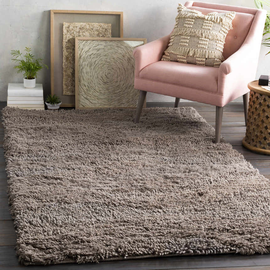 Living room scene with a plush Wharton Carpet, pink chair, and neutral-toned art for a cozy, contemporary feel. Roomscene-Rectangle