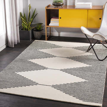 Living room scene with a beige Walkerston Hand Tufted Wool Rug featuring a modern black striped pattern. Roomscene-Rectangle