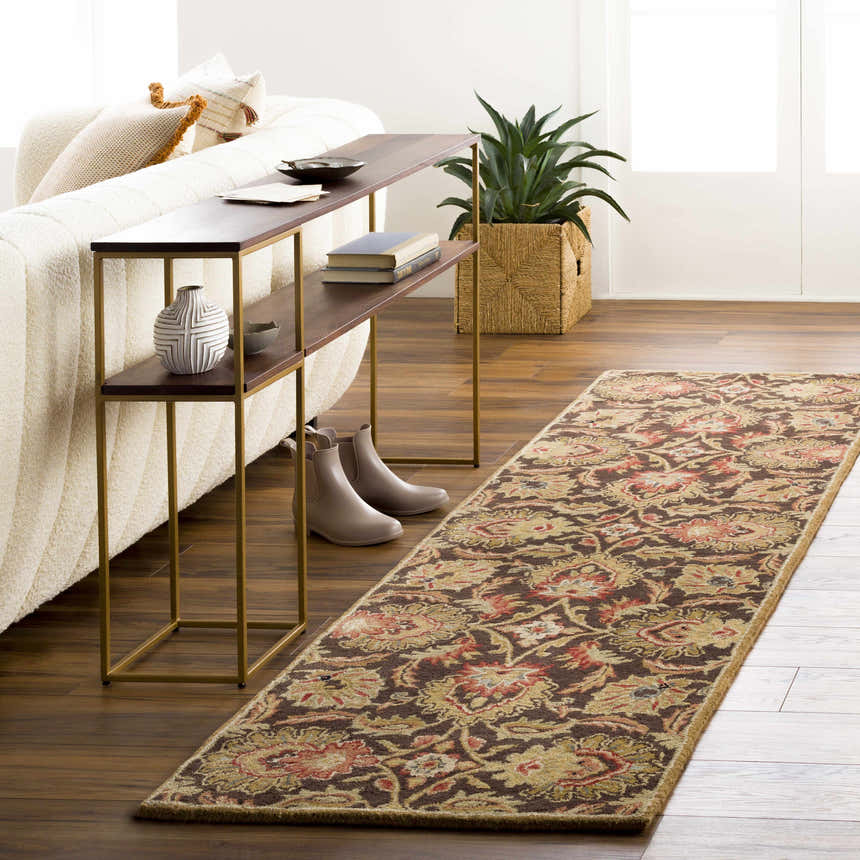 Living room scene with a brown floral Chesterton 1028 wool runner rug, console table, and neutral couch. Roomscene-Runner