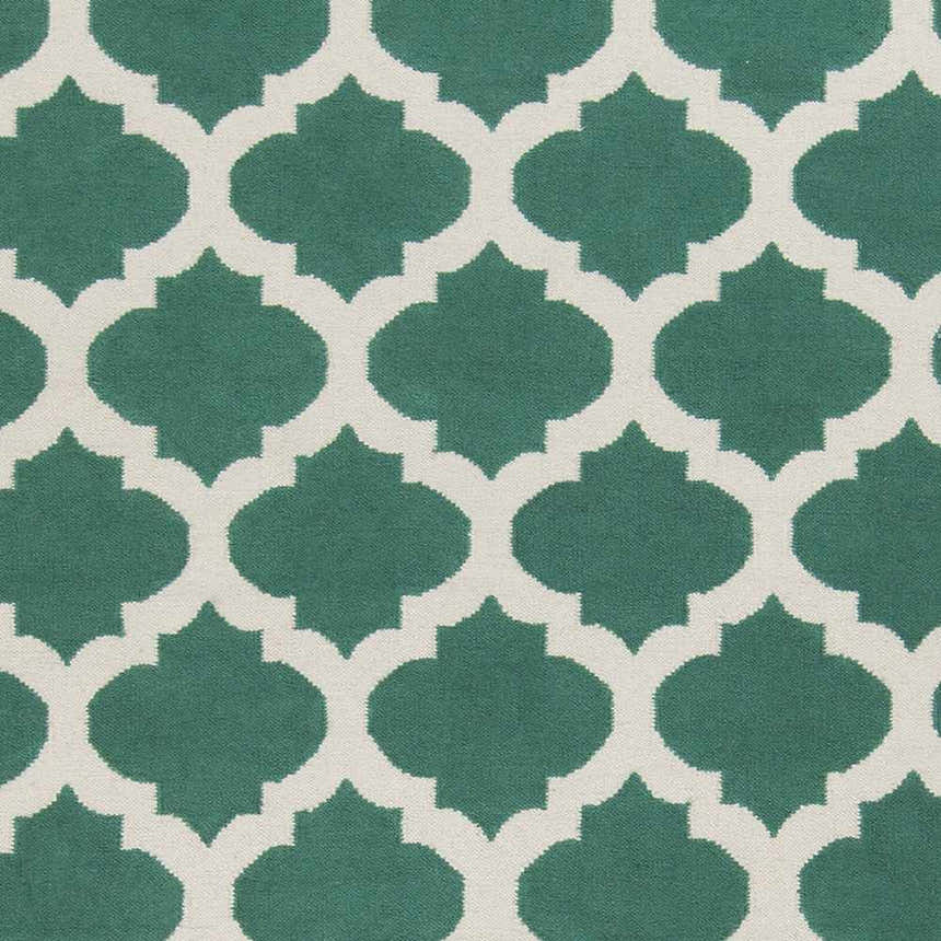 Close-up of the Worthington Area Rug: a hand-woven wool rug with a light beige and sage green quatrefoil pattern. Swatch