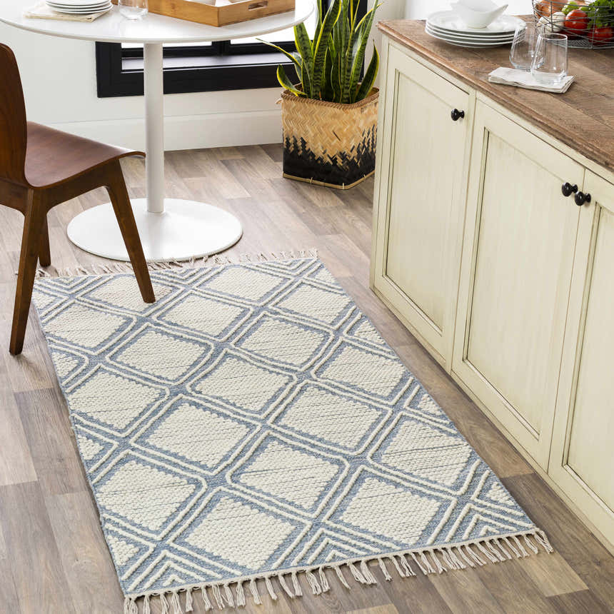 Kitchen scene with Wausa Denim Trellis on Cream rug, wood floors, white table, and cream cabinets. Roomscene-Runner