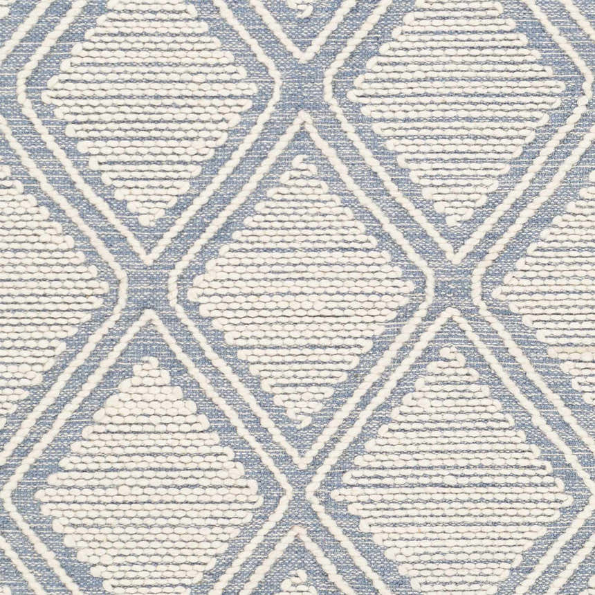 Close-up of Wausa Denim Trellis on Cream rug, featuring a geometric diamond pattern and textured hand-woven cotton/wool blend. Swatch