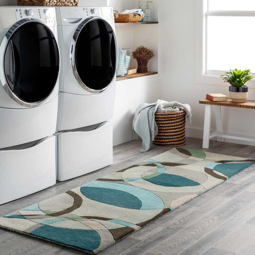 Laundry room with white washer and dryer, and Wyocena Wool Rug runner with aqua, green, and gray geometric design. Roomscene-Runner