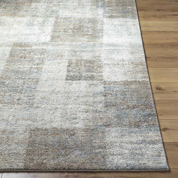 Close-up of the Xhosa Thick Luxe Rug. Beige, gray, and tan tones form a geometric pattern with a soft, plush texture. Front