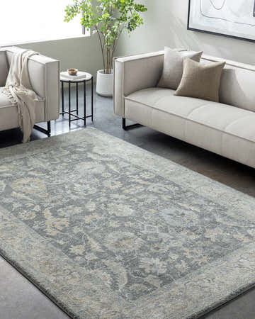 Living room scene with a Yetta Tan Thick Luxe Area Rug, light gray sofas, and a modern side table. Roomscene-Rectangle