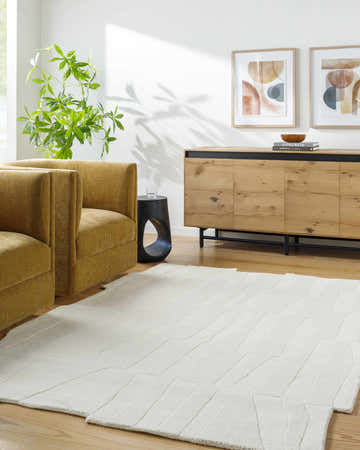 Living room scene with mustard armchairs and a Yonah White Abstract Area Rug. Roomscene-Rectangle