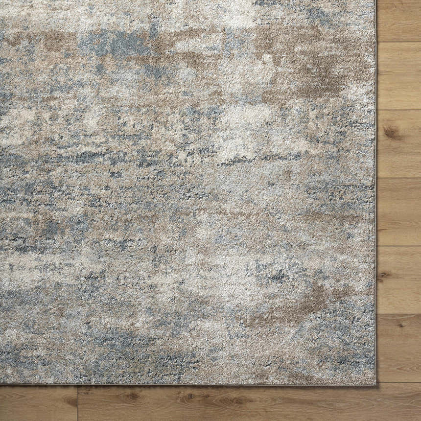 Close up of the Yoshe Thick Luxe Rug showing beige, gray, and tan hues with a contemporary pattern and soft texture. Corner