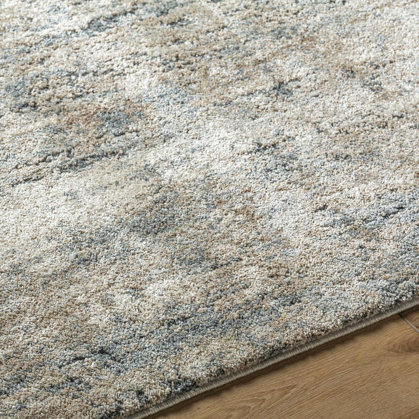 Close-up of the Yoshe Thick Luxe Rug showing its beige, gray, and tan contemporary pattern and plush texture. Texture