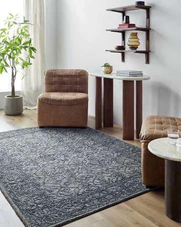 Living room scene with brown leather chairs and Yadid Black Wool Area Rug in charcoal and gray tones. Roomscene-Rectangle