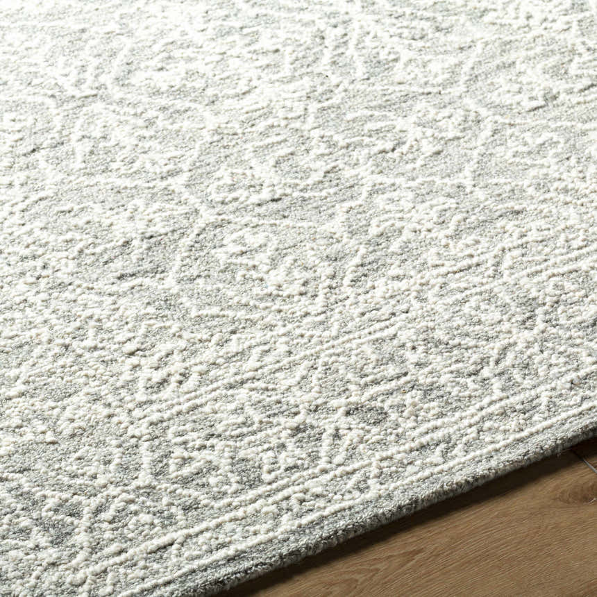 Close-up of the Yadid Gray Wool Area Rug showing its traditional pattern and soft, textured wool. Texture