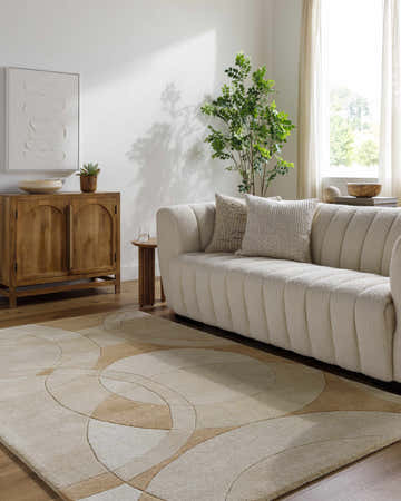 Living room with a modern sofa and a Yaxha Modern Wool Rug in camel, tan, and warm gray. Roomscene-Rectangle