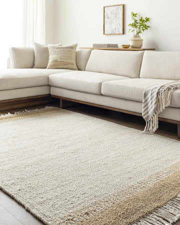 Living room scene with ivory sectional sofa and Yuuki Area Rug in ivory and tan jute. Roomscene-Rectangle
