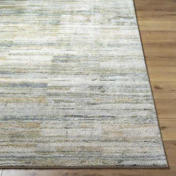 Close-up of the Yancy Thick Luxe Rug. Beige, gray, and olive hues create a contemporary stripe pattern. Soft, plush texture. Front