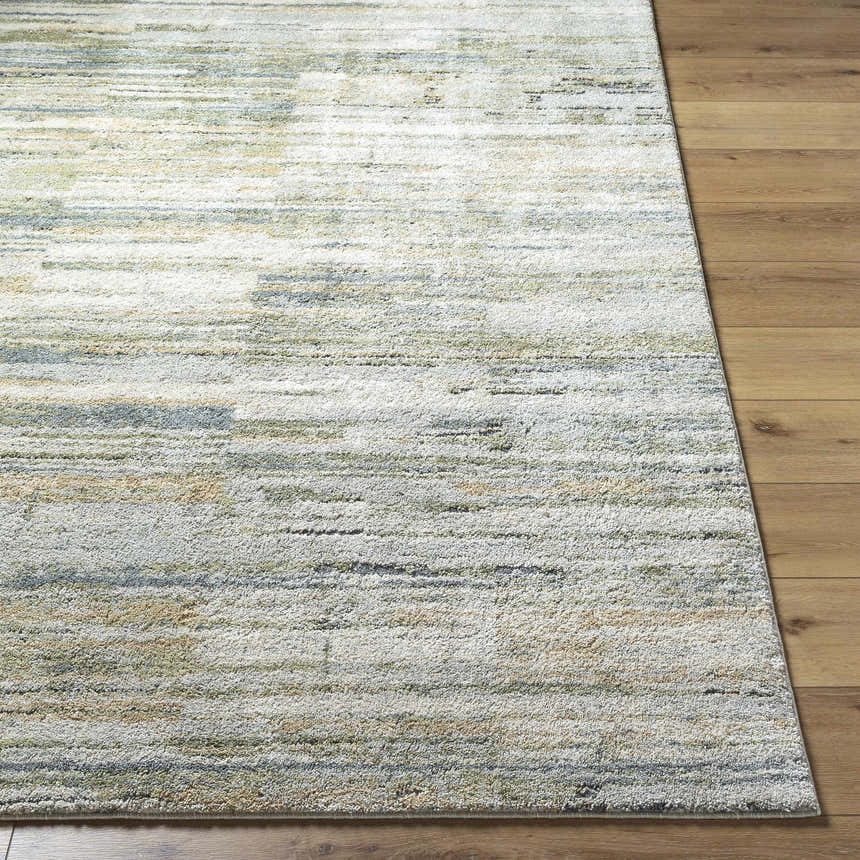 Close-up of the Yancy Thick Luxe Rug. Beige, gray, and olive hues create a contemporary stripe pattern. Soft, plush texture. Front