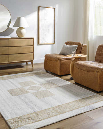 Living room scene with ash and silver gray Yagil Area Rug, brown leather chairs, and light wood dresser. Roomscene-Rectangle
