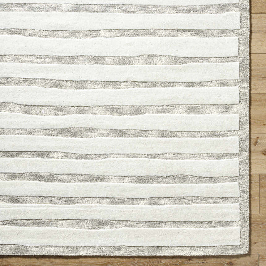 Close up of the Zerah Area Rug showing the ash and white horizontal stripe design and wool texture. Corner