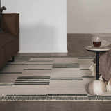 Living room scene with beige Aibonito Hand Tufted Wool Area Rug, brown couch, and marble side table. Modern, minimal style. Roomscene-Rectangle