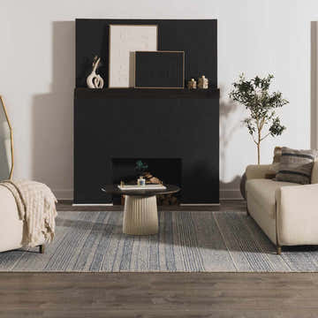 Living room scene with a blue striped Allport Tufted Maroc Wool Rug, beige sofa, black fireplace, and dark wood floors. Roomscene-Rectangle