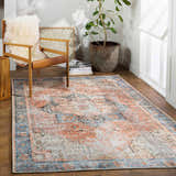 Farmhouse style room with wood chair and Livabliss Amelie AML-2309 rug in beige, dusty pink, light gray, pale blue, rust, and tan. Roomscene-Rectangle