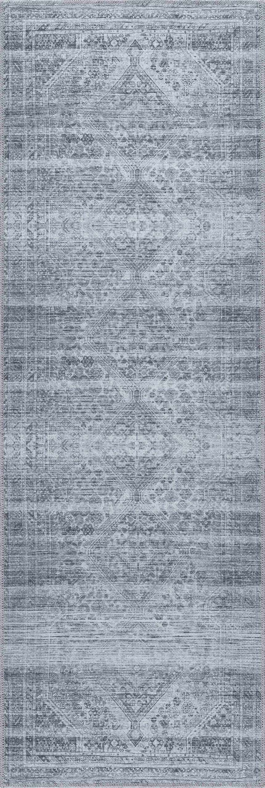 Close-up of the Barny Gray Blue Washable Rug. Features a traditional, distressed pattern in charcoal, blue and off-white tones. Design-Runner-2773