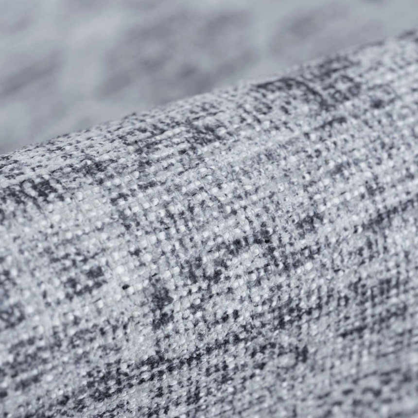 Close-up of the Barny Gray Blue Washable Rug, showing its woven texture and charcoal, gray, and off-white colors. Fold