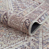 Close-up of the Barny Tan Washable Area Rug, showing its traditional pattern, chenille texture, and neutral tan, gray, and peach colors. Fold