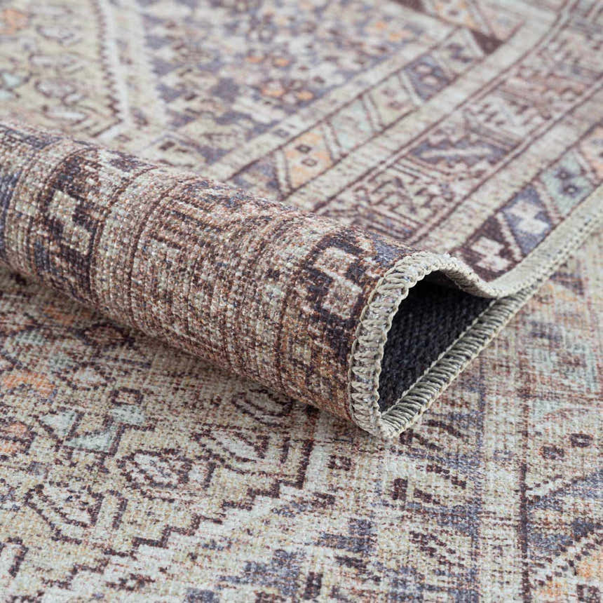 Close-up of the Barny Tan Washable Area Rug, showing its traditional pattern, chenille texture, and neutral tan, gray, and peach colors. Fold