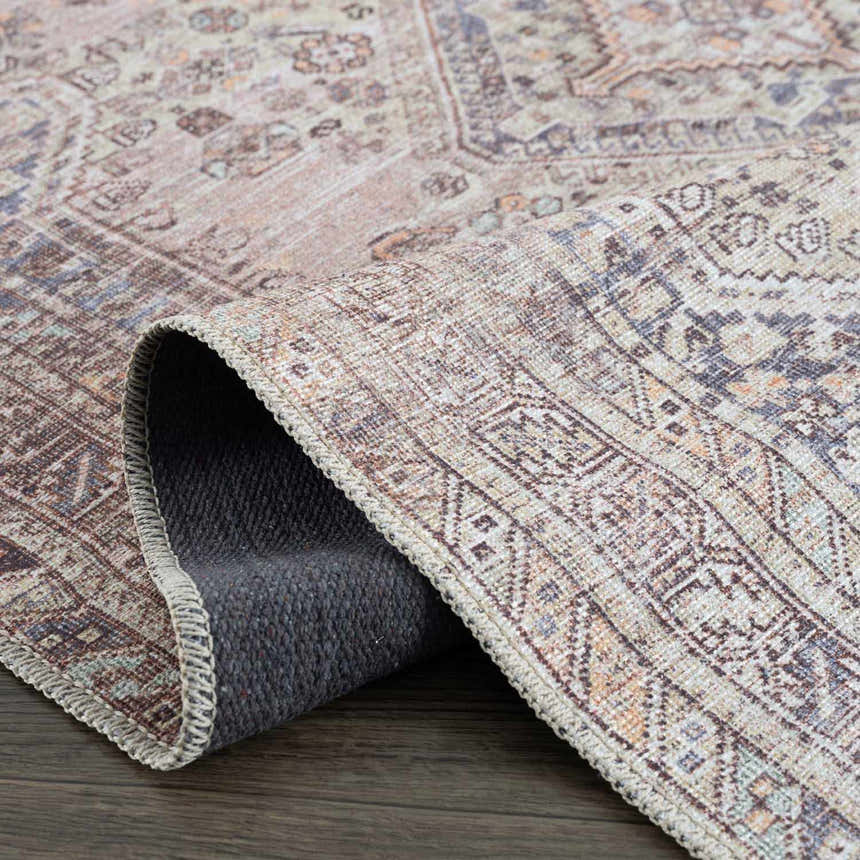 Close-up of the Barny Tan Washable Area Rug, showing its traditional pattern, soft texture, and colors like tan, gray, and slate blue. Fold
