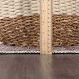 Close-up of Barny Tan Washable Area Rug showing rug thickness with a ruler. Tan, brown, and ivory tones. Pile