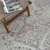 Close-up of the Barny Beige Flat Pile Washable Rug, showcasing its traditional pattern and neutral colors with black, gray, and peach accents. Styleshot