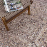 Close-up of the Barny Brown Flat Pile Washable Rug, showcasing its traditional pattern and neutral cream and brown color palette. Styleshot