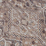 Close-up of the Barny Brown Flat Pile Washable Rug, showcasing its geometric pattern and cream, light brown, and medium gray colors. Texture