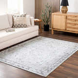 Living room with a cream sofa and gray Haile Boutique Washable Rug on dark wood floors. Roomscene-Rectangle