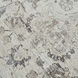 Close up of the Haile Boutique Washable Rug showing its traditional floral pattern and soft gray, brown and nutmeg colors. Texture