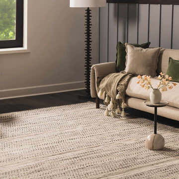 Living room scene with beige sofa and Arabi Wool Area Rug in black, gray, and light beige. Roomscene-Rectangle