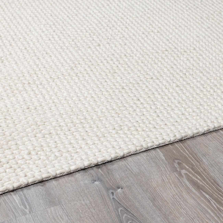 Close up of the hand woven texture of the Lucerne Plain Cream Wool Rug. Pile
