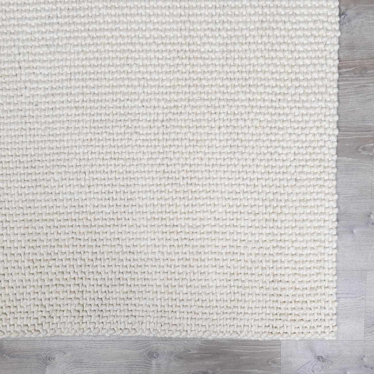Close-up of the hand woven Lucerne Plain Cream Wool Rug showing texture and color. Swatch