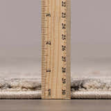 Close-up of the Vaeda Blue & Beige Thick Luxe Rug showing its plush pile height with a ruler for scale. Pile