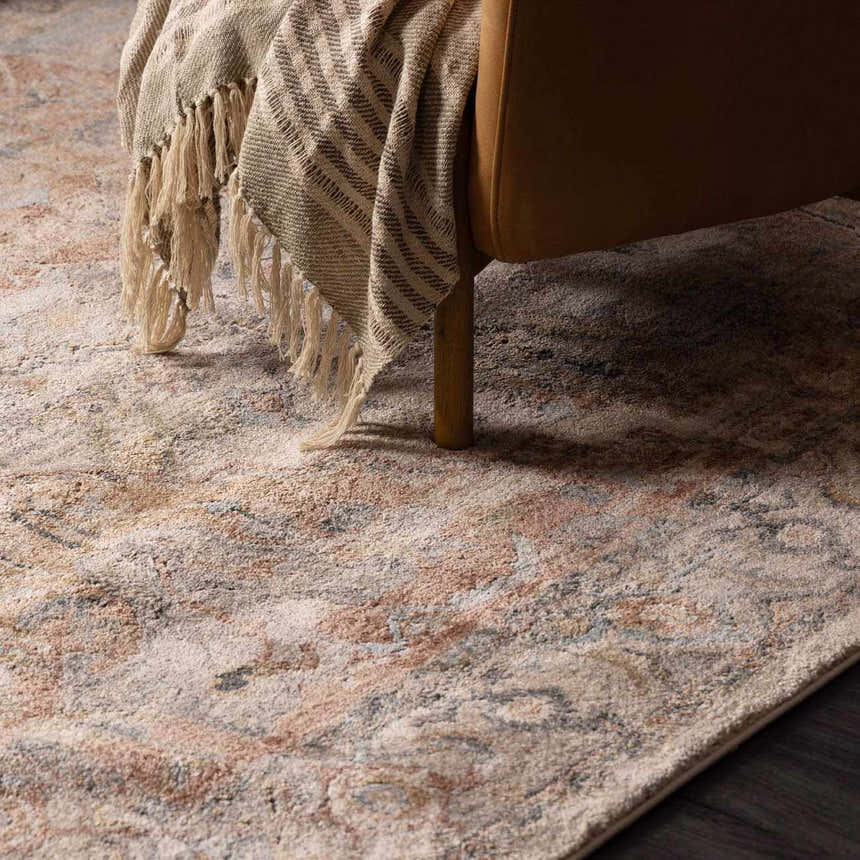 Close-up of the Vaeda Blue & Beige rug showing its beige, pink, and gray tones, and traditional design. Styleshot
