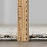 Close-up of the Vaeda Blue Thick Luxe Rug showing its plush pile height with a ruler. Pile